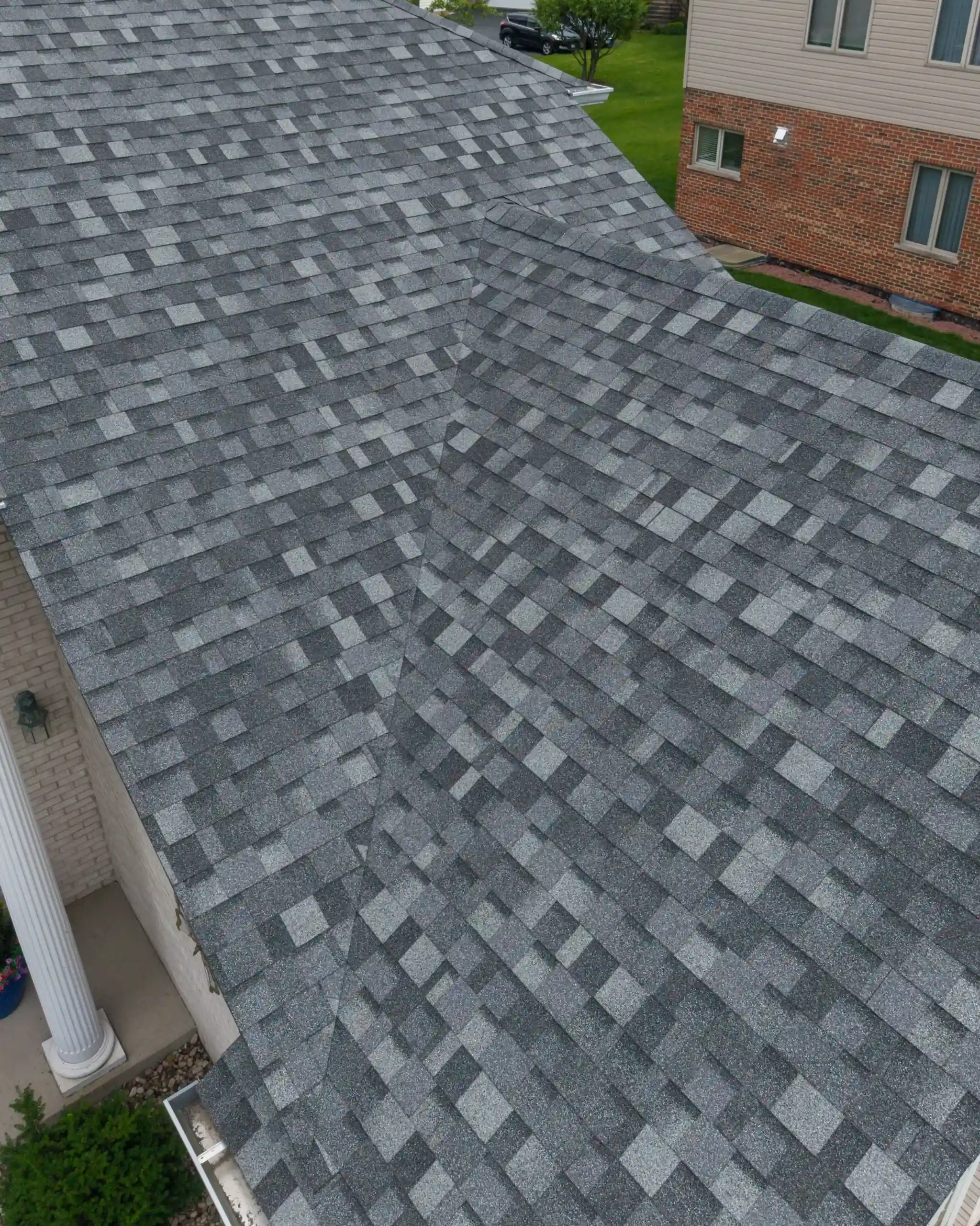 Seamless gutters and downspouts on a recently completed roof